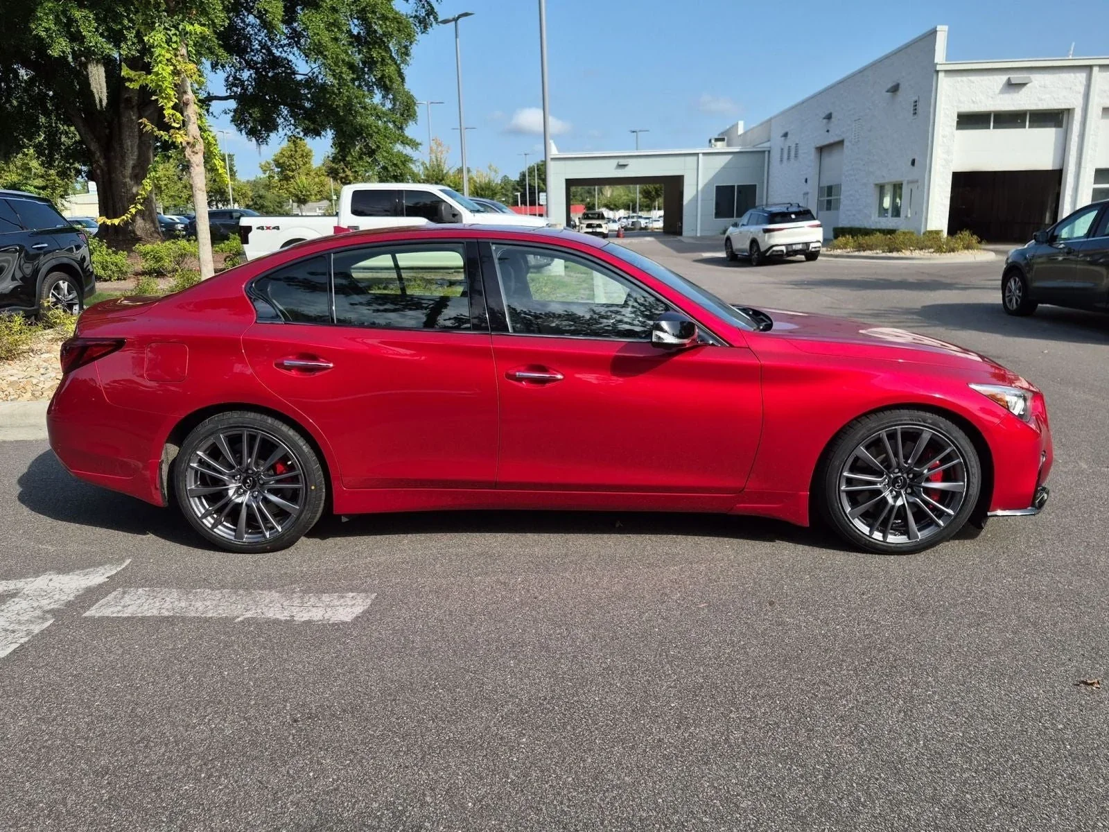 Used 2023 INFINITI Q50 Red Sport 400 side profile with red brake calipers, Wilmington NC